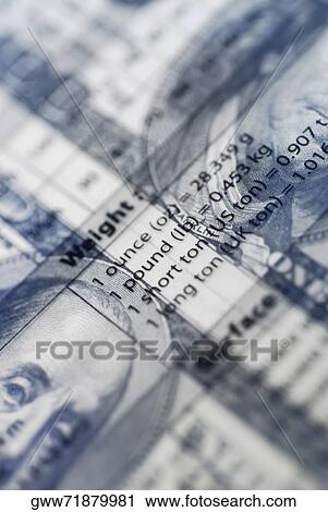 Close-up of weight conversion table supper imposed on American paper currency View Large Photo Image Stock Image - Close-up of weight conversion table supper imposed on American paper currency. Fotosearch