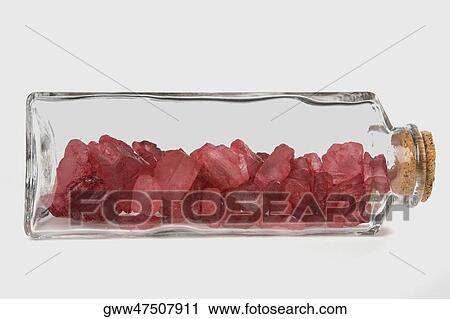 Stock Image - Crystals of camphor in a bottle. Fotosearch
