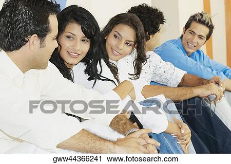 Five friends sitting together and smiling View Large Photo Image Stock Image - Five friends sitting together and smiling. Fotosearch