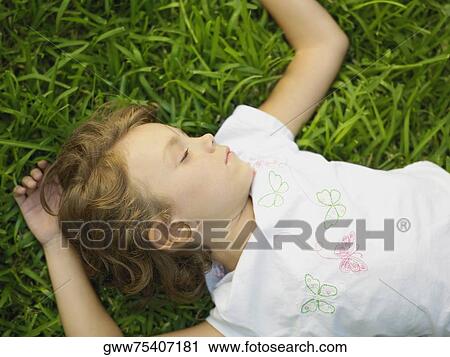 Stock Image - Girl sleeping on the grass. Fotosearch