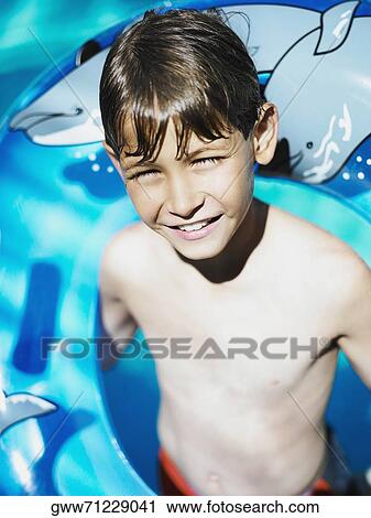High angle view of a boy in a swimming pool View Large Photo Image Stock Image - High angle view of a boy in a swimming pool. Fotosearch