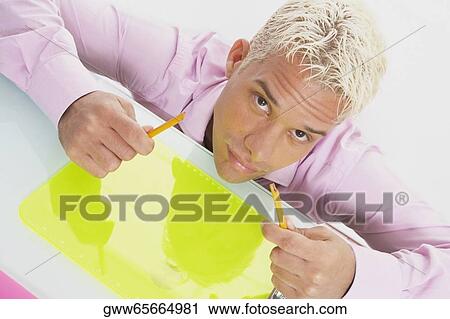 Stock Image - High angle view of a businessman breaking a pencil. Fotosearch