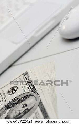 High angle view of a laptop with one hundred dollar bills View Large Photo Image Stock Image - High angle view of a laptop with one hundred dollar bills. Fotosearch