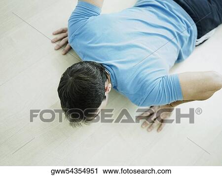 High angle view of a mid adult man exercising View Large Photo Image Stock Image - High angle view of a mid adult man exercising. Fotosearch