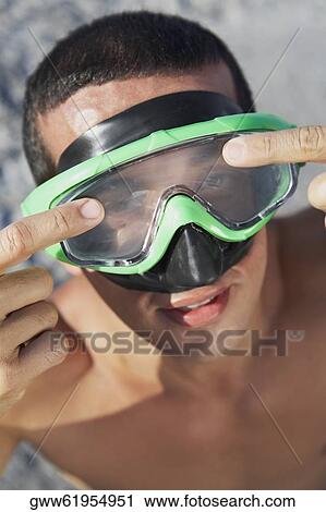 High angle view of a mid adult man wearing swimming goggles View Large Photo Image Stock Image - High angle view of a mid adult man wearing swimming goggles. Fotosearch