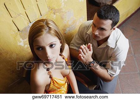 High angle view of a young man pleading in front of a young woman View Large Photo Image Stock Image - High angle view of a young man pleading in front of a young woman. Fotosearch