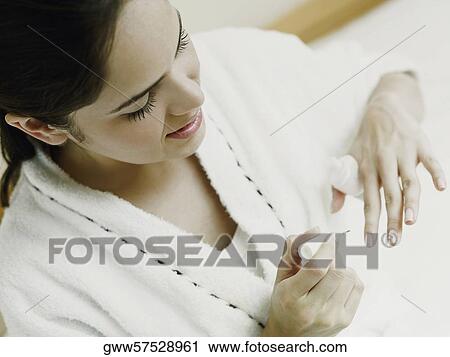High angle view of a young woman polishing her nails View Large Photo Image Stock Image - High angle view of a young woman polishing her nails. Fotosearch