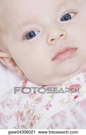 High angle view of baby girl lying on her back View Large Photo Image Stock Image - High angle view of baby girl lying on her back. Fotosearch