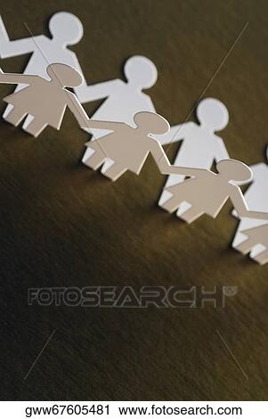 Stock Image - High angle view of paper chain dolls. Fotosearch