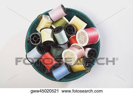 High angle view of spools of threads in a bowl View Large Photo Image Stock Image - High angle view of spools of threads in a bowl. Fotosearch