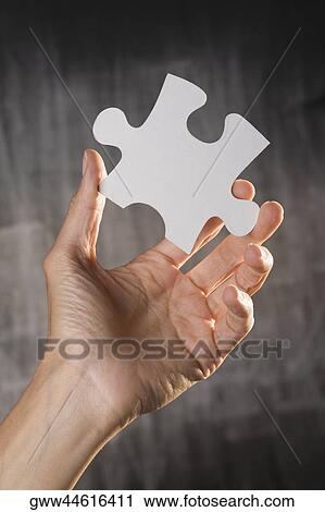 Human hand holding a jigsaw piece View Large Photo Image Stock Image - Human hand holding a jigsaw piece. Fotosearch