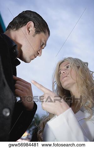 Low angle view of a businesswoman blaming a businessman View Large Photo Image Stock Image - Low angle view of a businesswoman blaming a businessman. Fotosearch
