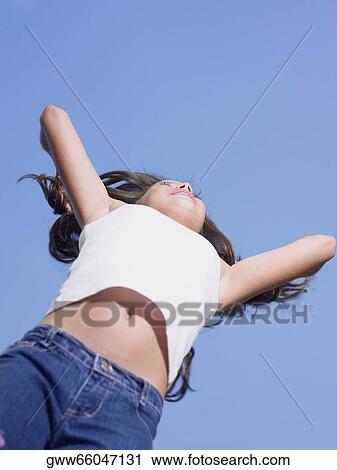 Stock Image - Low angle view of a girl. Fotosearch