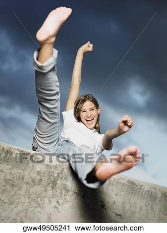 Low angle view of a teenage girl shouting with her arms outstretched View Large Photo Image Stock Image - Low angle view of a teenage girl shouting with her arms outstretched. Fotosearch
