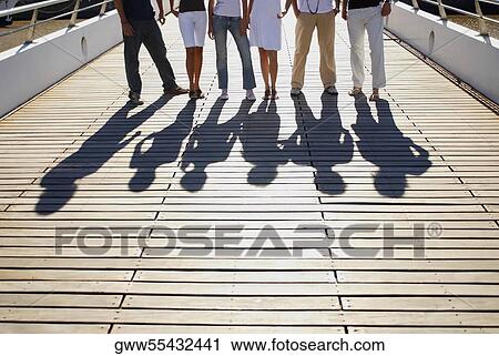 Low section view of a group of friends standing on a footbridge View Large Photo Image Stock Image - Low section view of a group of friends standing on a footbridge. Fotosearch