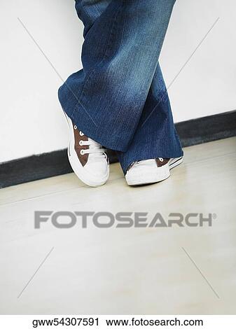 Low section view of a person standing View Large Photo Image Stock Image - Low section view of a person standing. Fotosearch