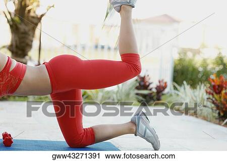 Low section view of a woman exercising on an exercise mat View Large Photo Image Stock Image - Low section view of a woman exercising on an exercise mat. Fotosearch