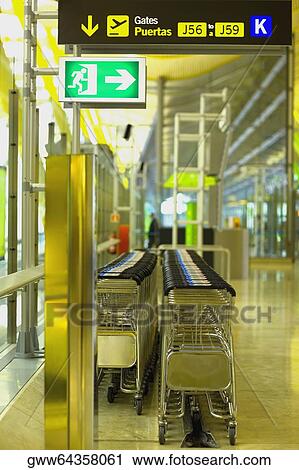 Luggage carts in a lobby at an airport, Madrid, Spain View Large Photo Image Stock Image - Luggage carts in a lobby at an airport, Madrid, Spain. Fotosearch