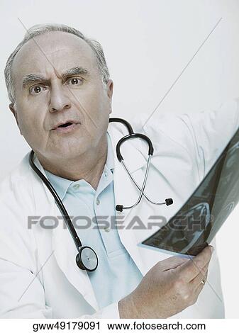 Male doctor holding an X-Ray View Large Photo Image Stock Image - Male doctor holding an X-Ray. Fotosearch