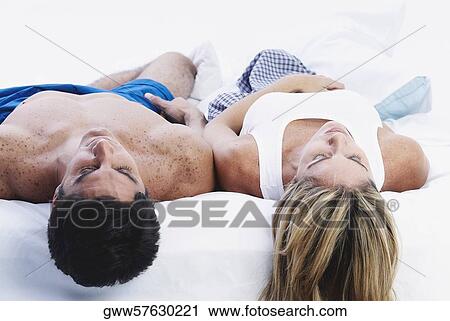 Mid adult couple sleeping on the bed View Large Photo Image Stock Image - Mid adult couple sleeping on the bed. Fotosearch