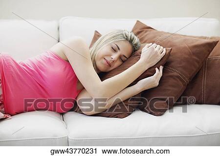 Mid adult woman sleeping on a couch View Large Photo Image Stock Image - Mid adult woman sleeping on a couch. Fotosearch