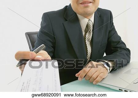 Mid section view of a businessman holding a check and a pen View Large Photo Image Stock Image - Mid section view of a businessman holding a check and a pen. Fotosearch