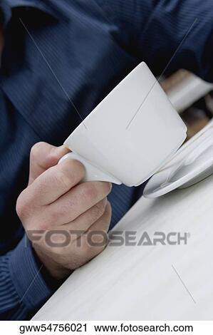 Mid section view of a man holding a cup of tea View Large Photo Image Stock Image - Mid section view of a man holding a cup of tea. Fotosearch
