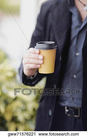 Mid section view of a man holding a disposable cup View Large Photo Image Stock Image - Mid section view of a man holding a disposable cup. Fotosearch