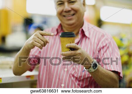 Mid section view of a mature man pointing towards a can View Large Photo Image Stock Image - Mid section view of a mature man pointing towards a can. Fotosearch
