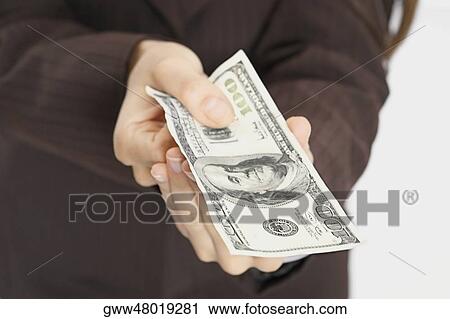 Mid section view of a woman holding American paper currency View Large Photo Image Stock Image - Mid section view of a woman holding American paper currency. Fotosearch