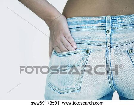 Mid section view of a woman standing with her hand in her pocket View Large Photo Image Stock Image - Mid section view of a woman standing with her hand in her pocket. Fotosearch