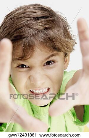 Portrait of a boy clenching his teeth View Large Photo Image Stock Image - Portrait of a boy clenching his teeth. Fotosearch