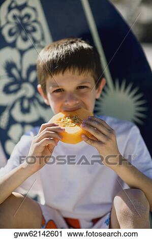 Portrait of a boy eating a slice of melon View Large Photo Image Stock Image - Portrait of a boy eating a slice of melon. Fotosearch