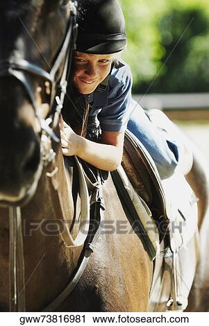 Portrait of a boy horseback riding View Large Photo Image Stock Image - Portrait of a boy horseback riding. Fotosearch
