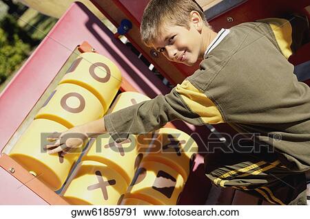 Portrait of a boy playing tic-tac-toe View Large Photo Image Stock Image - Portrait of a boy playing tic-tac-toe. Fotosearch