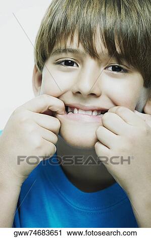 Portrait of a boy stretching his mouth View Large Photo Image Stock Image - Portrait of a boy stretching his mouth. Fotosearch