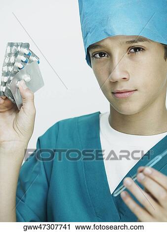 Portrait of a boy wearing surgical scrubs and holding blister packs View Large Photo Image Stock Image - Portrait of a boy wearing surgical scrubs and holding blister packs. Fotosearch