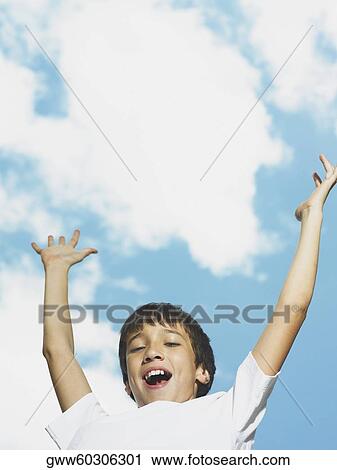 Portrait of a boy with his arms raised View Large Photo Image Stock Image - Portrait of a boy with his arms raised. Fotosearch
