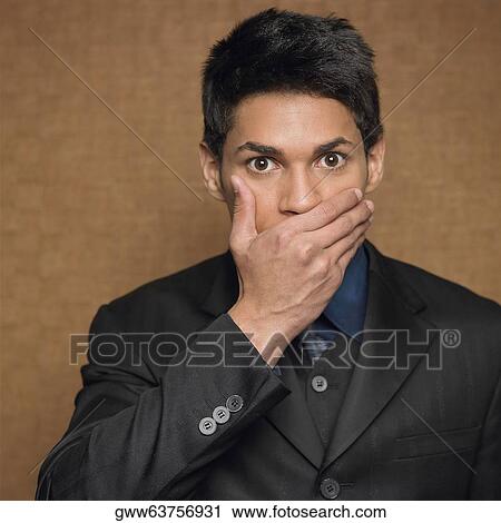 Portrait of a businessman covering his mouth with his hand View Large Photo Image Stock Image - Portrait of a businessman covering his mouth with his hand. Fotosearch