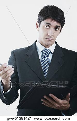 Portrait of a businessman holding a file and a pen View Large Photo Image Stock Image - Portrait of a businessman holding a file and a pen. Fotosearch