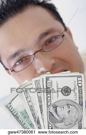 Portrait of a businessman holding American dollar bills View Large Photo Image Stock Image - Portrait of a businessman holding American dollar bills. Fotosearch