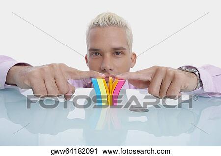 Portrait of a businessman playing with a notepad View Large Photo Image Stock Image - Portrait of a businessman playing with a notepad. Fotosearch