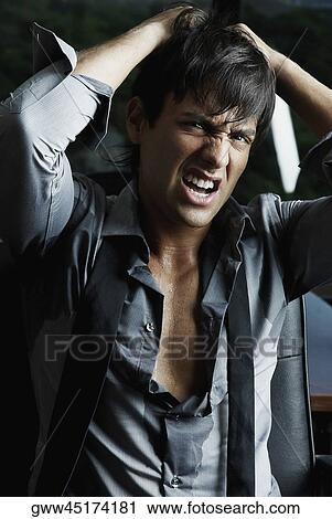 Portrait of a businessman pulling his hair in anger View Large Photo Image Stock Image - Portrait of a businessman pulling his hair in anger. Fotosearch