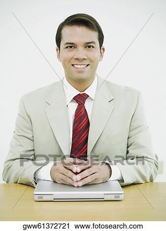 Portrait of a businessman smiling with his hands on a laptop View Large Photo Image Stock Image - Portrait of a businessman smiling with his hands on a laptop. Fotosearch