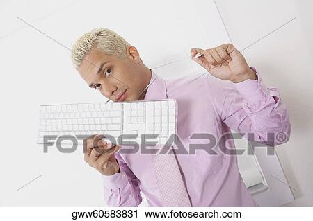 Stock Image - Portrait of a businessman using a computer cable as a noose. Fotosearch