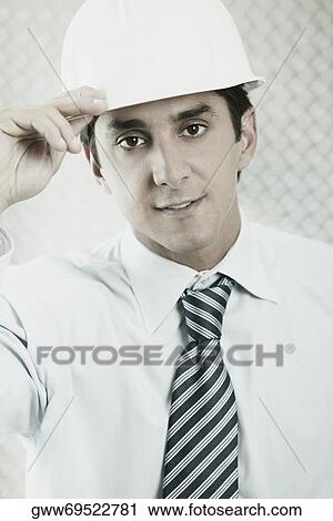 Portrait of a businessman wearing a hardhat View Large Photo Image Stock Image - Portrait of a businessman wearing a hardhat. Fotosearch
