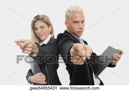 Portrait of a businesswoman and a businessman standing back to back and pointing View Large Photo Image Stock Image - Portrait of a businesswoman and a businessman standing back to back and pointing. Fotosearch
