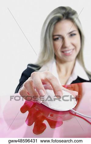 Portrait of a businesswoman holding a computer mouse and smiling View Large Photo Image Stock Image - Portrait of a businesswoman holding a computer mouse and smiling. Fotosearch
