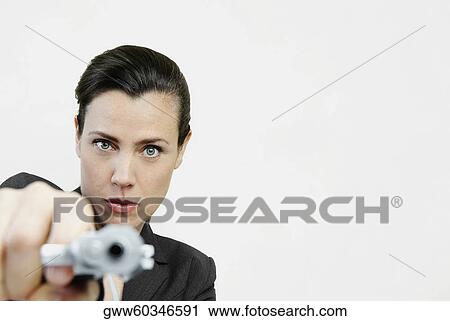 Portrait of a businesswoman pointing a gun View Large Photo Image Stock Image - Portrait of a businesswoman pointing a gun. Fotosearch