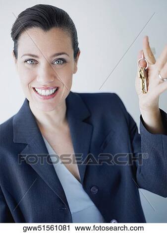 Portrait of a businesswoman smiling with holding keys View Large Photo Image Stock Image - Portrait of a businesswoman smiling with holding keys. Fotosearch